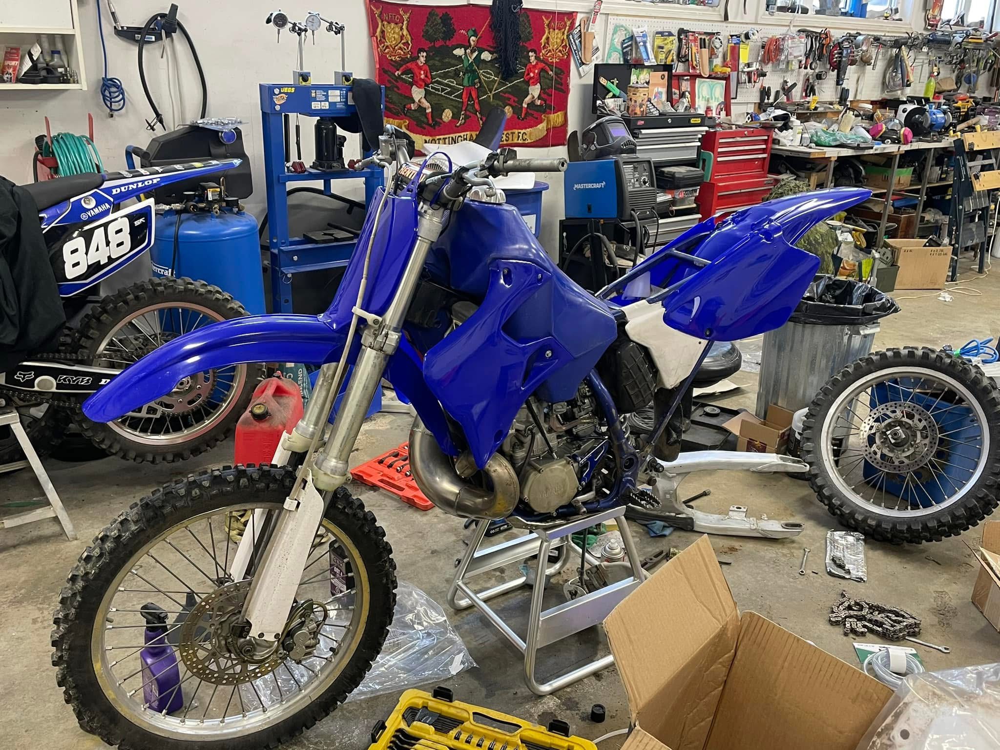Blue motocross project bike in a workshop